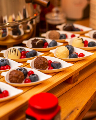 An interesting dessert consisting of fruit and chocolate balls served